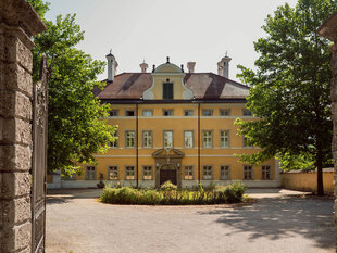 Schloss Hellbrunn in Salzburg front view with green trees around
